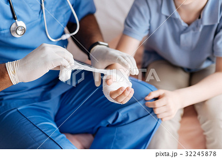Close up of male hands while dressing disabled Close up of male hands while dressing disabled 32245878