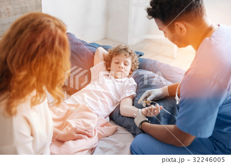 Serious boy giving his hand for prick while 32246005