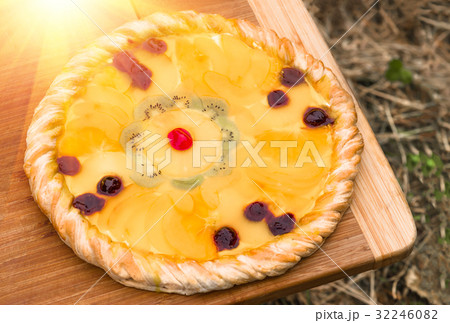 Fruit pizza with pineapple, orange, kiwi, cherry 32246082