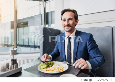 Joyful male manager having lunch in cafe 32247511