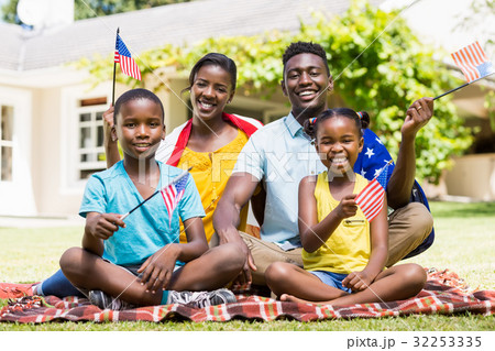 Happy family showing usa flag Happy family showing usa flag 32253335