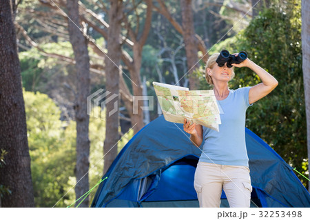 Mature woman looking on binoculars Mature woman looking on binoculars 32253498