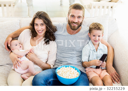 Family having fun while watching television Family having fun while watching television 32255229