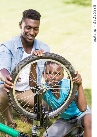 Happy family repairing a bike 32255538