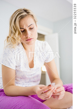 Young woman looking at medicine 32255539