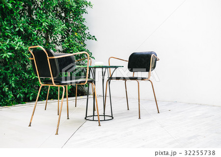 Furnitures with empty chair and table 32255738