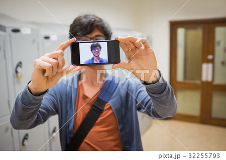 Student taking his selfie on smartphone Student taking his selfie on smartphone 32255793