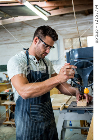 Carpenter using a drill 32255794