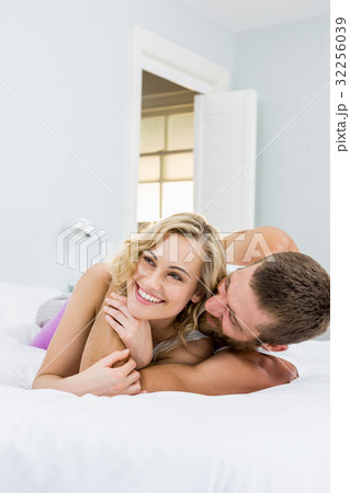 Young couple embracing on bed Young couple embracing on bed 32256039