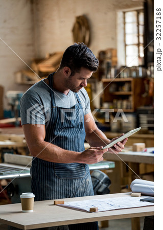 carpenter using his tablet carpenter using his tablet 32257188