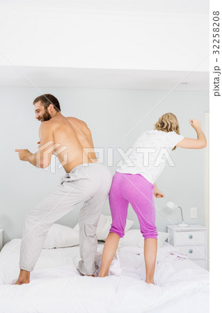 Young couple dancing on bed Young couple dancing on bed 32258208