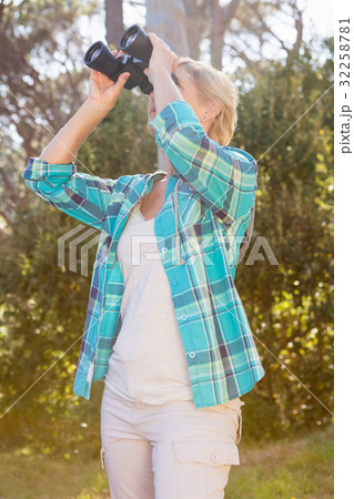 Mature woman looking on binoculars 32258781