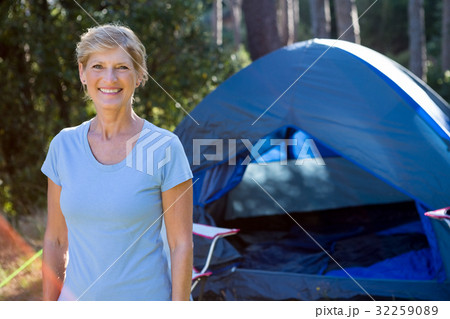 Senior woman standing in front of a tent 32259089