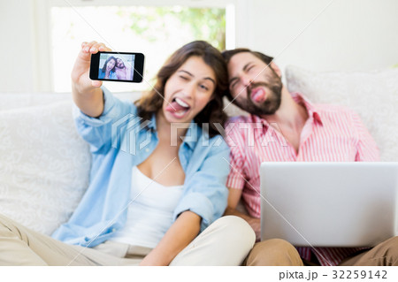 Couple taking a selfie on mobile phone Couple taking a selfie on mobile phone 32259142