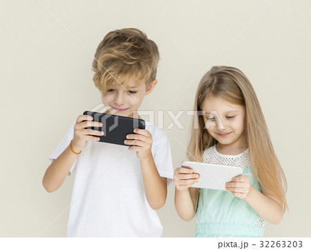 Young Kids Playing Mobile Phone Young Kids Playing Mobile Phone 32263203