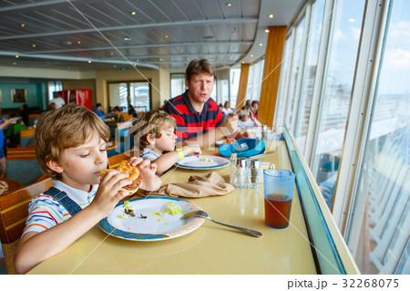 Two preschool kids boys and father eating 32268075