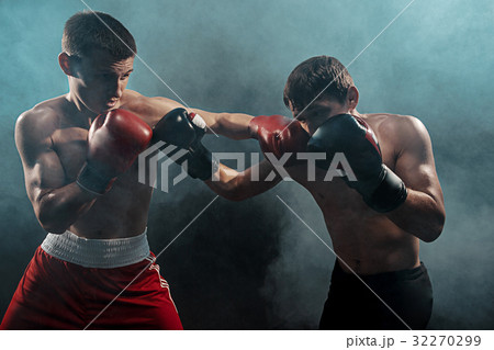 Two professional boxer boxing on black smoky Two professional boxer boxing on black smoky 32270299