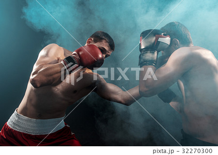 Two professional boxer boxing on black smoky 32270300