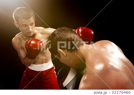 Two professional boxer boxing on black background, 32270460