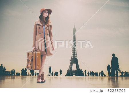Redhead girl with suitcase and Eiffel tower 32273705