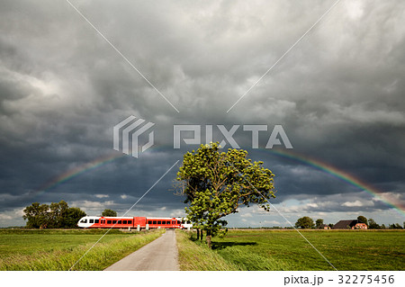 rainbow over railroad with train 32275456