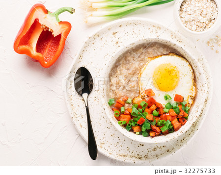 Savory oatmeal, served with vegetables and fried Savory oatmeal, served with vegetables and fried 32275733