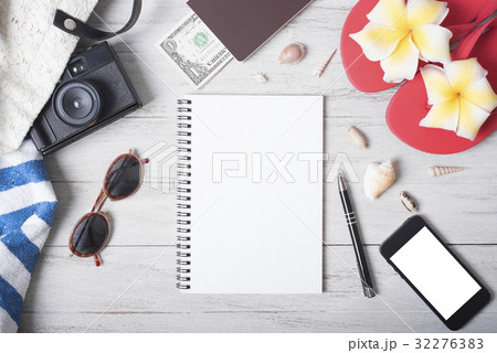 Holiday travel notebook with accessories on wood 32276383