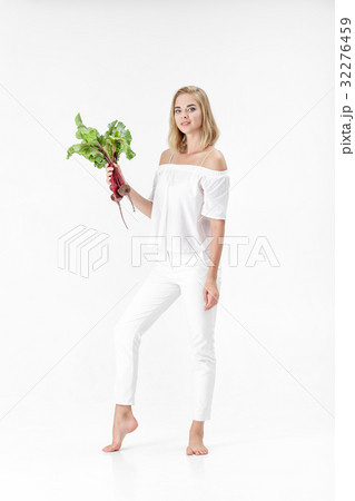 Beautiful blond woman holds beetroot with green 32276459