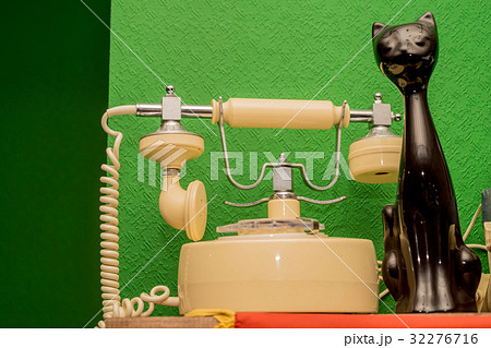 Old beige disk phone on wooden background 32276716