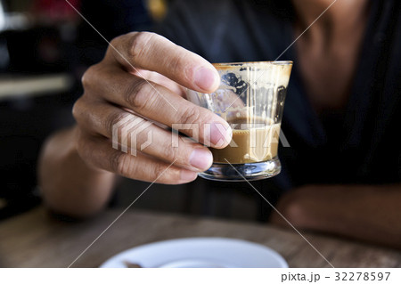 young man with a macchiato in a coffeehouse young man with a macchiato in a coffeehouse 32278597
