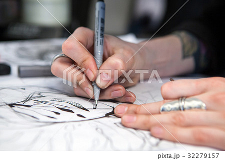 Girl tattoo artist draws a sketch. Close-up of Girl tattoo artist draws a sketch. Close-up of 32279157