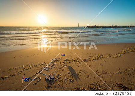Straya text, flag and thongs on beach 32279455