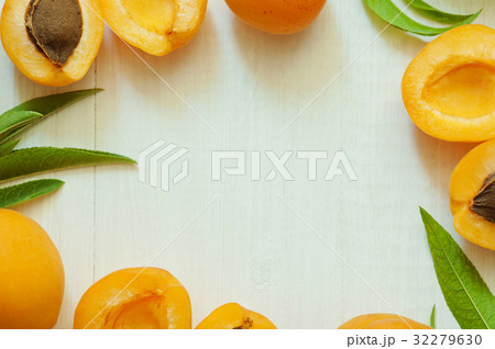 Frame background of ripe apricots on a white Frame background of ripe apricots on a white 32279630