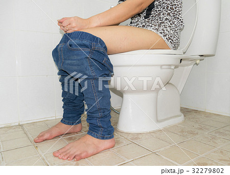 Woman with constipation sitting on toilet legs 32279802