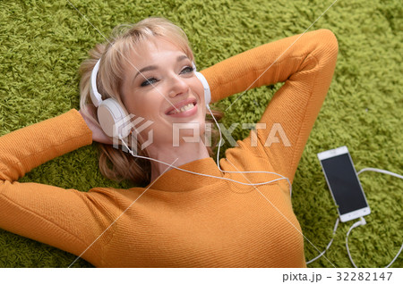 young woman listening music in headphones 32282147