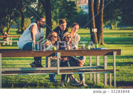 Multi-ethnic group of friends taking a selfie with Multi-ethnic group of friends taking a selfie with 32283848