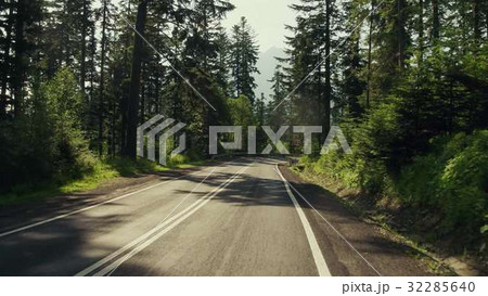 Car road bend in mountainuos forest and speed 32285640