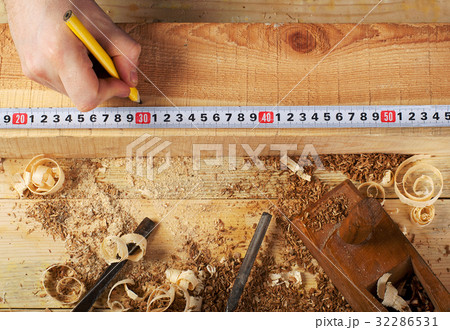 carpenter working,hammer,meter and screw-driver on carpenter working,hammer,meter and screw-driver on 32286531