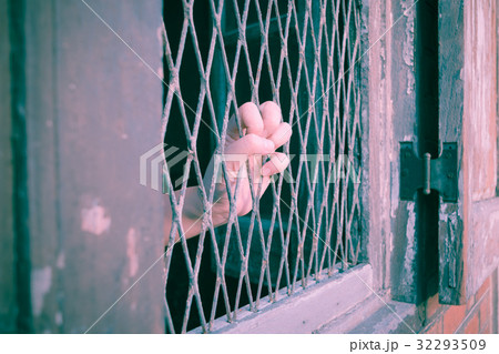 Hands of the man on a steel lattice close up , vintage style 32293509