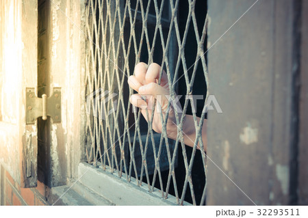 Hands of the man on a steel lattice close up Hands of the man on a steel lattice close up 32293511