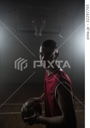 Portrait of basketball player holding a ball Portrait of basketball player holding a ball 32297705