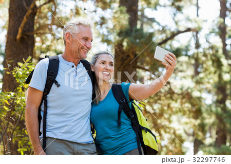 Couple smiling and taking a photo Couple smiling and taking a photo 32297746
