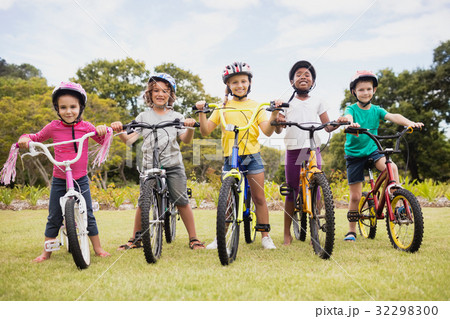 Happy children wearing helmet and posing on their bike 32298300