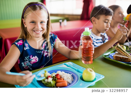 Children eating at the canteen Stock Photo by ©Wavebreakmedia 108962978
