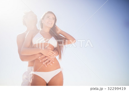 Low angle view of couple embracing Low angle view of couple embracing 32299419