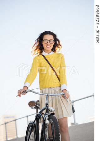Hipster walking her bike 32299663