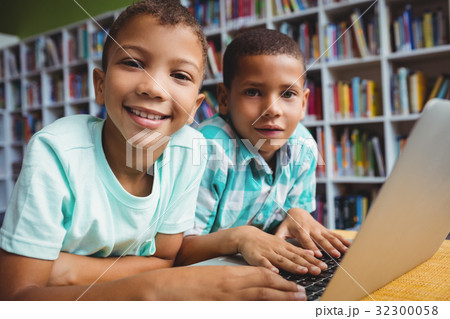 Little boys using a laptop Little boys using a laptop 32300058