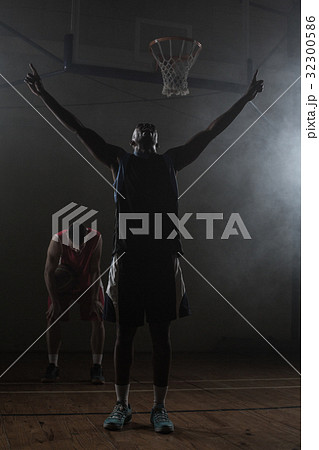 Victorious basketball player raising his arms up 32300586