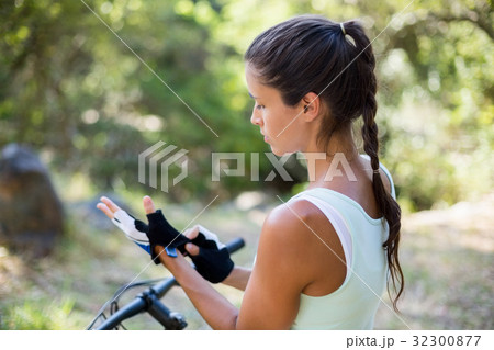 Concentrated woman preparing ride bike 32300877