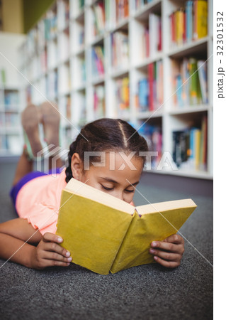 Girl lying and reading a book Girl lying and reading a book 32301532